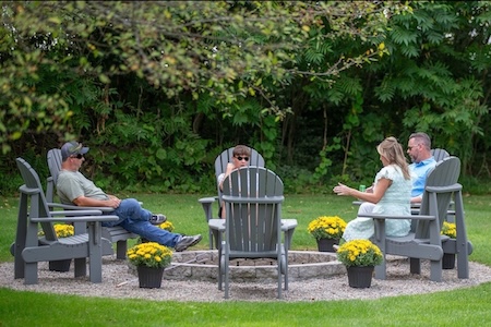 Chairs around a firepit in the backyard